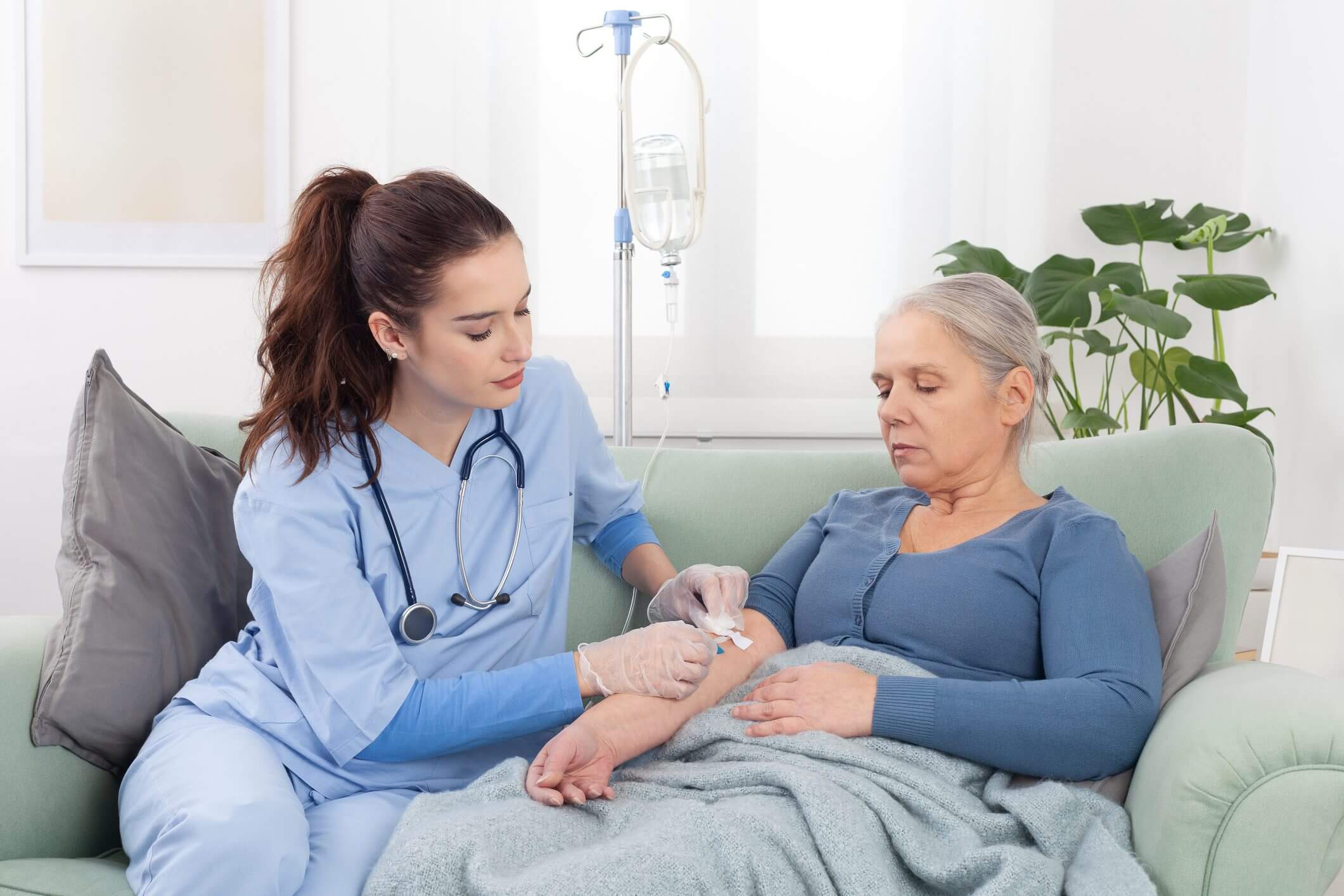 Nurse caring for elderly woman at home.