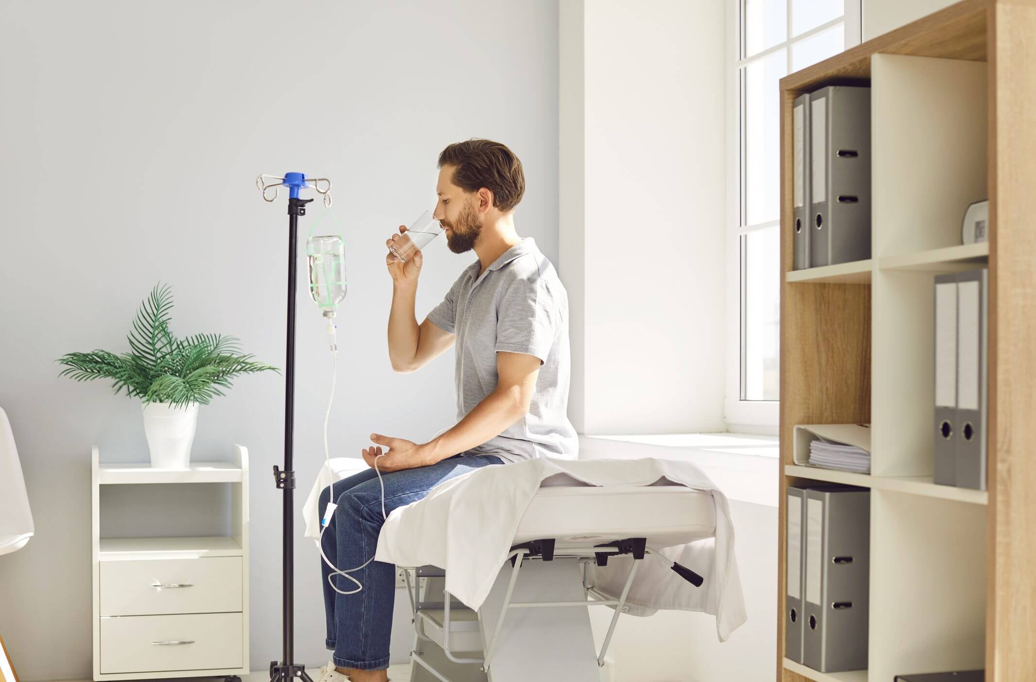 Man drinking water in a medical clinic.