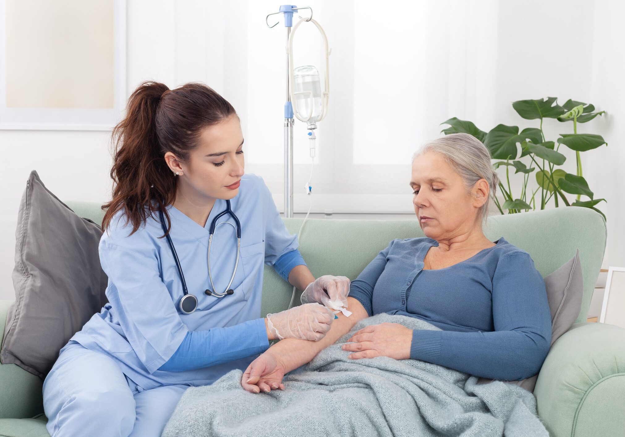Nurse caring for elderly woman at home.