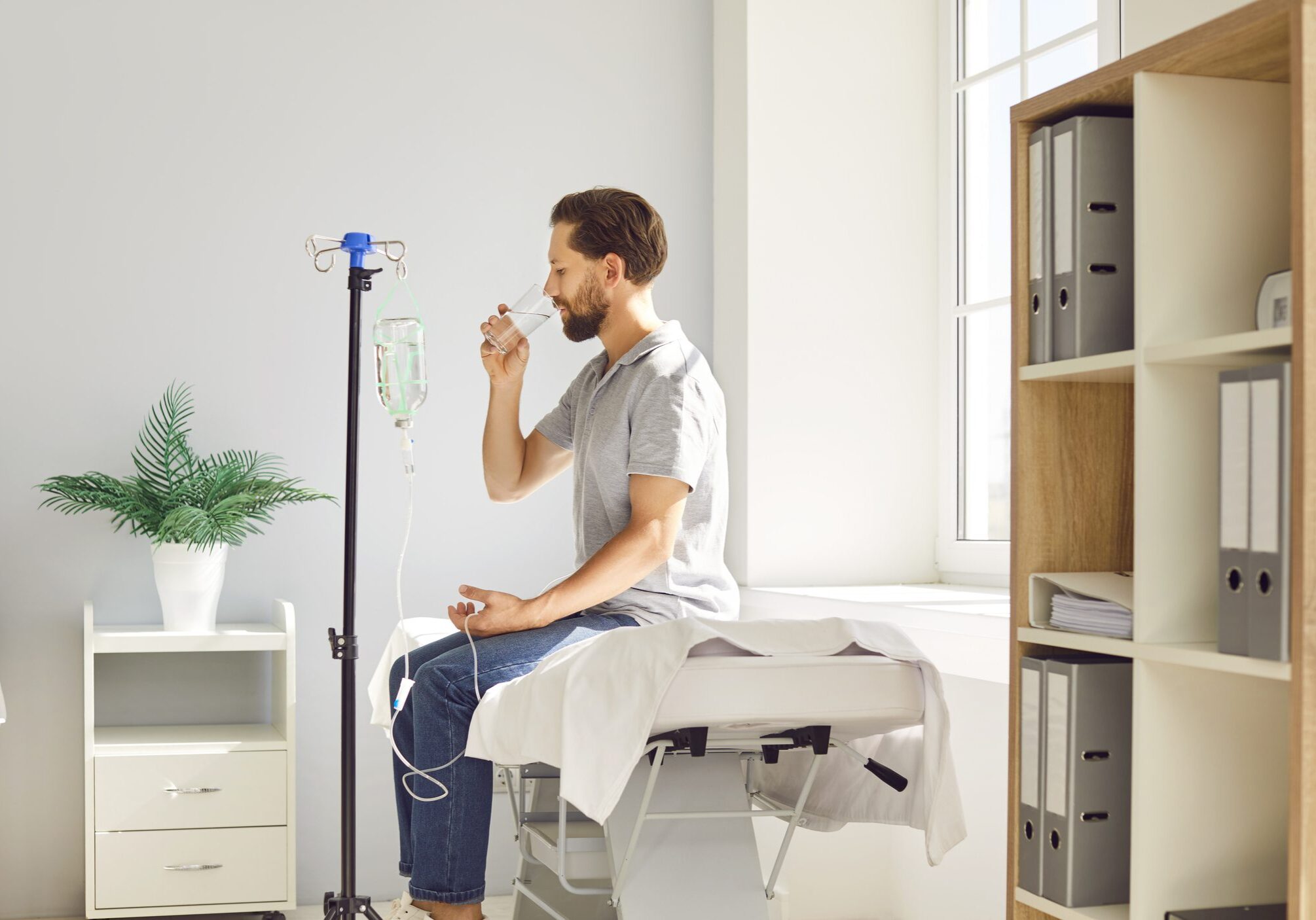 Man drinking water in a medical clinic.